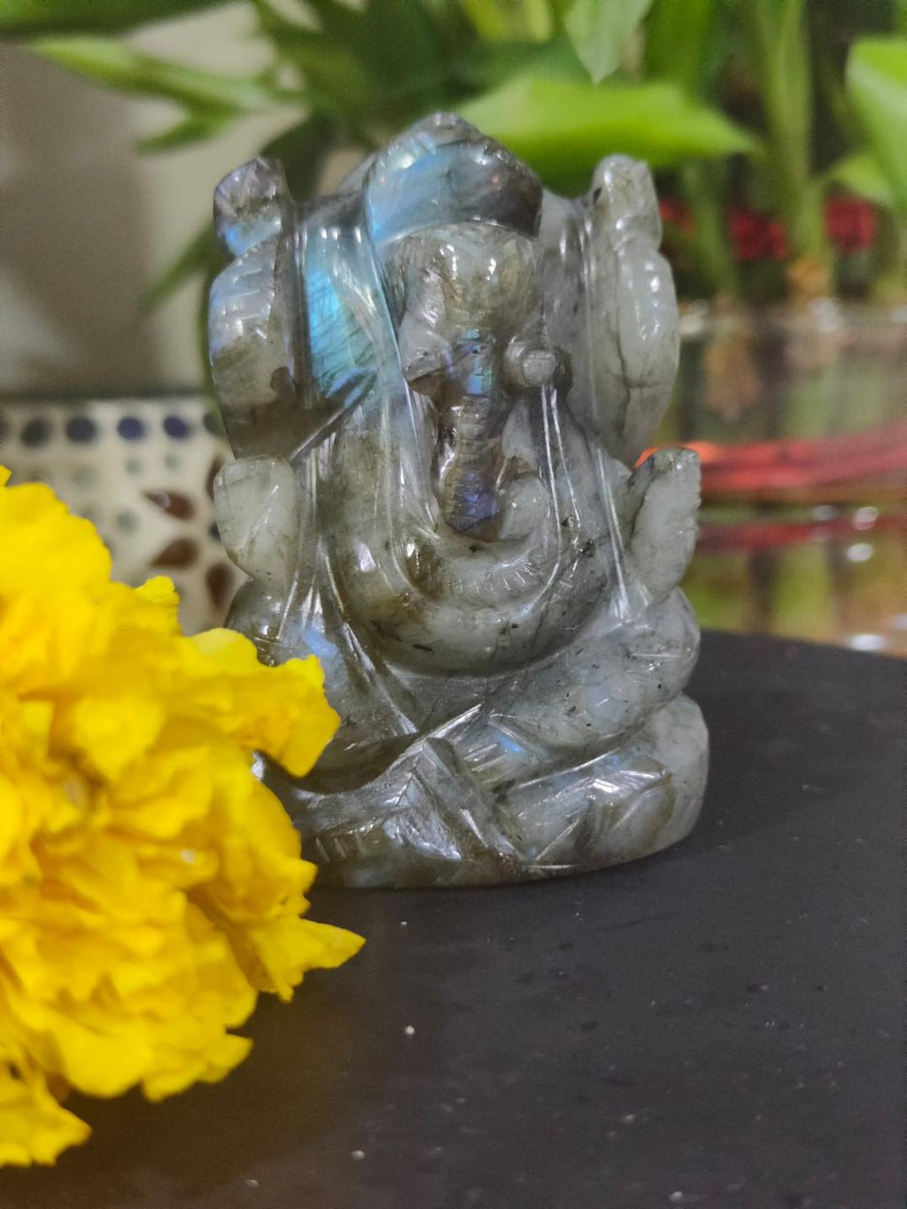 Labradorite Ganesha Idol with marigold flowers