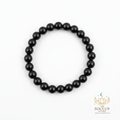 Black Tourmaline 8mm crystal bracelet flat lay on white background with SoulUp Store logo